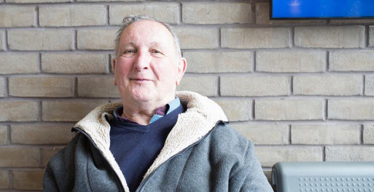 man sat in front of a brick wall