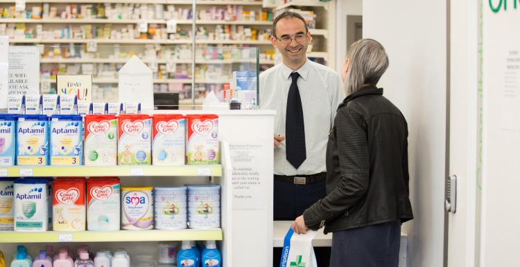 Person collecting prescription at Pharmacy