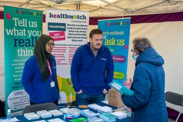 Healthwatch Liverpool staff talking to a member of the public at an event