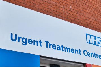 NHS Urgent Treatment Centre signage. NHS logo and blue text on white background.