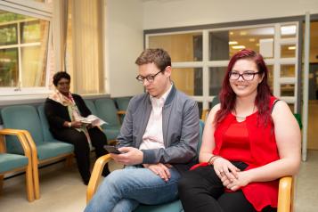 Two people in a waiting room