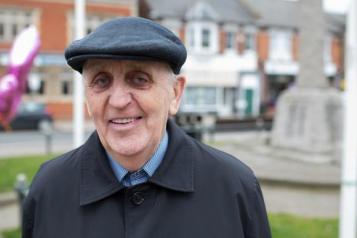 Man in a flat cap standing outside