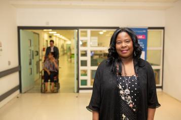 image of woman standing in a hospital corridor