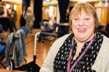 Woman smiling at a Healthwatch event