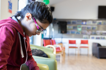 young person looking at their phone